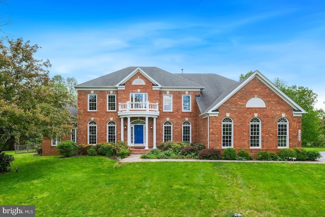 14309 Cervantes Ave, Darnestown, MD 20874 - colonial inspired home featuring a balcony, a front lawn, brick siding, and roof with shingles