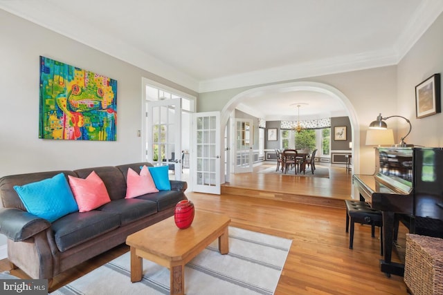 14309 Cervantes Ave, Darnestown, MD 20874 - living area with arched walkways, french doors, wood finished floors, a chandelier, and ornamental molding