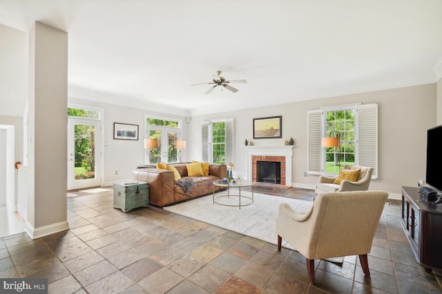 14309 Cervantes Ave, Darnestown, MD 20874 - living room with stone tile flooring, plenty of natural light, ceiling fan, and a brick fireplace