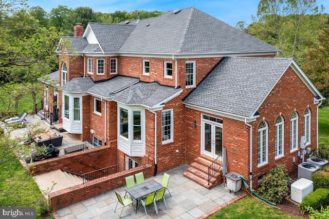 14309 Cervantes Ave, Darnestown, MD 20874 - rear view of property with entry steps, a chimney, roof with shingles, and a patio