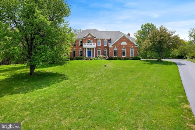 14309 Cervantes Ave, Darnestown, MD 20874 - georgian-style home with brick siding, a front lawn, and a chimney