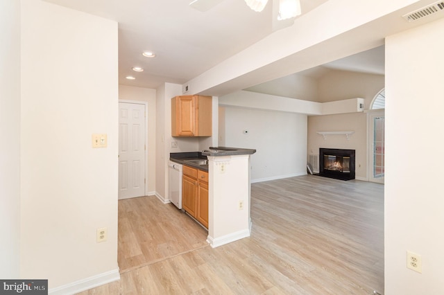 6905 Victoria Dr Unit 6905-L, Alexandria, VA 22310 - kitchen with dark countertops, light wood-style flooring, a glass covered fireplace, open floor plan, and light brown cabinetry