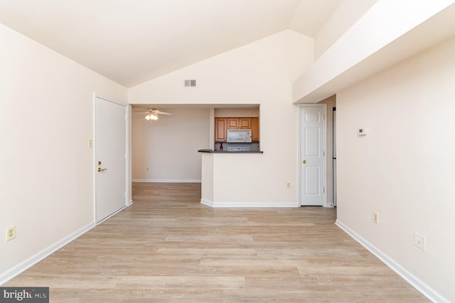 6905 Victoria Dr Unit 6905-L, Alexandria, VA 22310 - unfurnished living room with vaulted ceiling, light wood-style flooring, and a ceiling fan