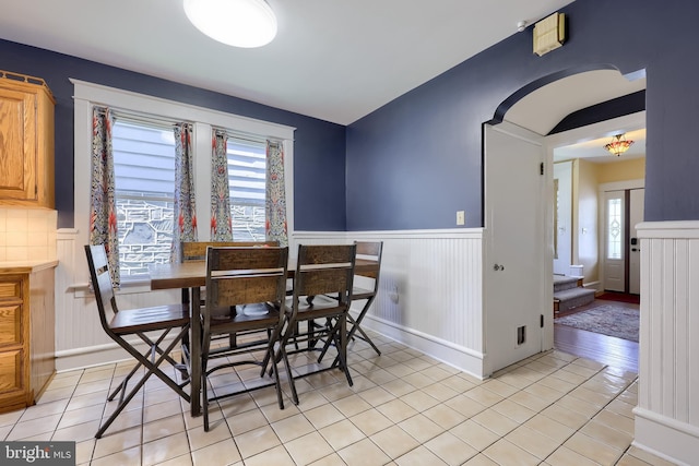 76 N Grant St, Manheim, PA 17545 - dining space featuring wainscoting, light tile patterned floors, and arched walkways