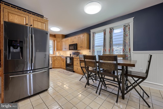 76 N Grant St, Manheim, PA 17545 - kitchen featuring black appliances, a wainscoted wall, and light tile patterned floors