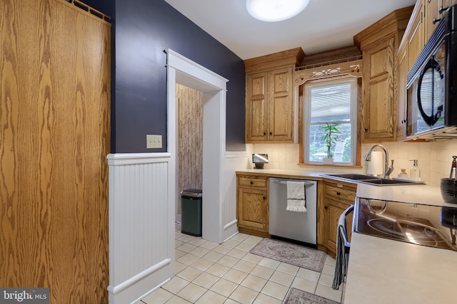 76 N Grant St, Manheim, PA 17545 - kitchen with dishwasher, black microwave, wainscoting, light countertops, and decorative backsplash