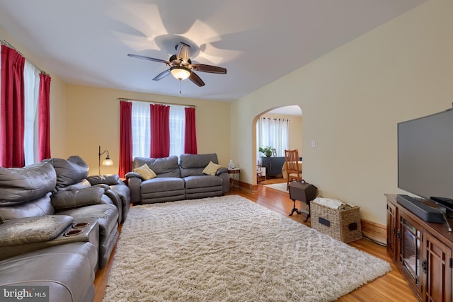 76 N Grant St, Manheim, PA 17545 - living area with arched walkways, a ceiling fan, and light wood-style floors