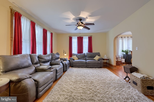 76 N Grant St, Manheim, PA 17545 - living room with arched walkways, light wood-style floors, and a ceiling fan