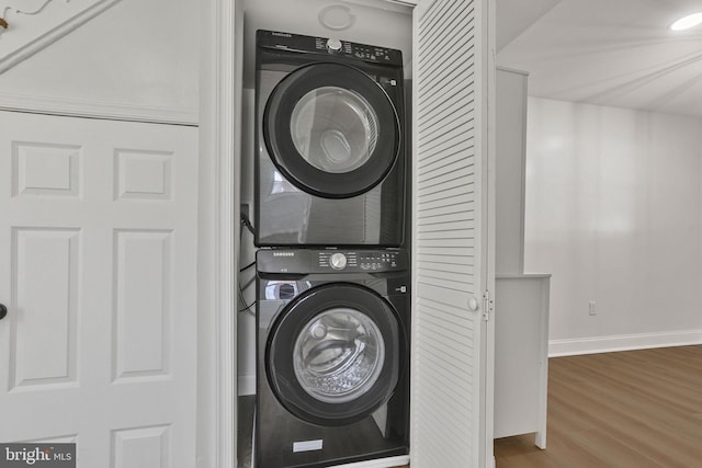1700 Melbourne Rd, Baltimore, MD 21222 - laundry area featuring stacked washer and clothes dryer and wood finished floors