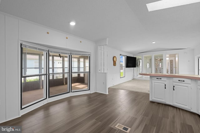15 Bristol Way Unit 36841, Lewes, DE 19958 - kitchen featuring lofted ceiling, dark wood finished floors, white cabinetry, a skylight, and open floor plan
