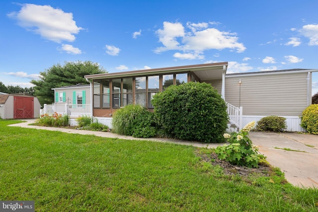 15 Bristol Way Unit 36841, Lewes, DE 19958 - rear view of property with a storage shed, a sunroom, and a yard