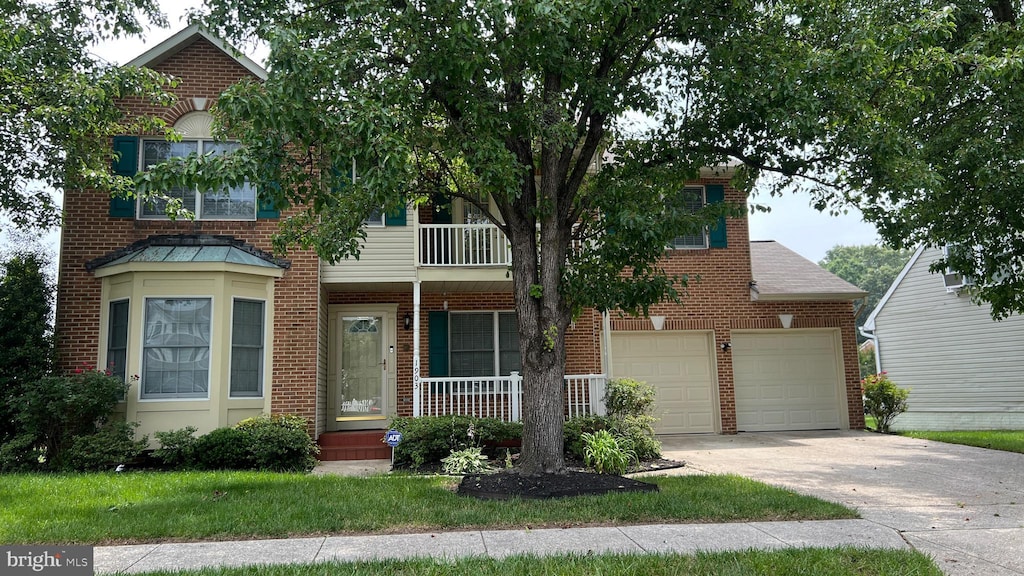 1903 Brigade Way, Odenton, MD 21113 - view of front facade featuring brick siding, driveway, a balcony, and covered porch