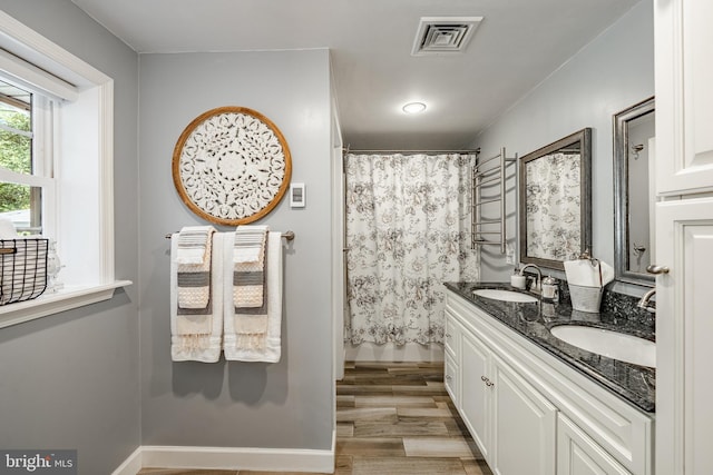 1225 Shenkel Rd, Pottstown, PA 19465 - bathroom with double vanity, wood finished floors, and a shower with shower curtain