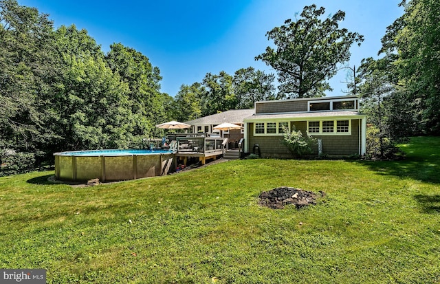 1225 Shenkel Rd, Pottstown, PA 19465 - rear view of house with a wooden deck, an outdoor pool, and a lawn