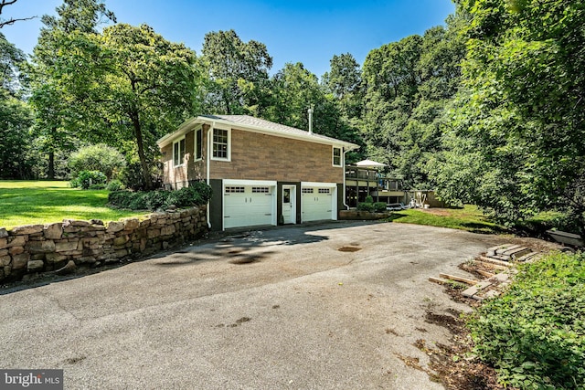1225 Shenkel Rd, Pottstown, PA 19465 - view of side of property with driveway, a lawn, a garage, and a wooden deck