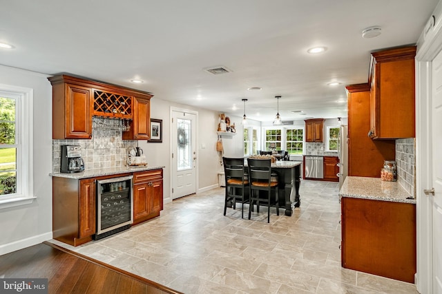 1225 Shenkel Rd, Pottstown, PA 19465 - kitchen with wine cooler, appliances with stainless steel finishes, brown cabinets, decorative backsplash, and recessed lighting