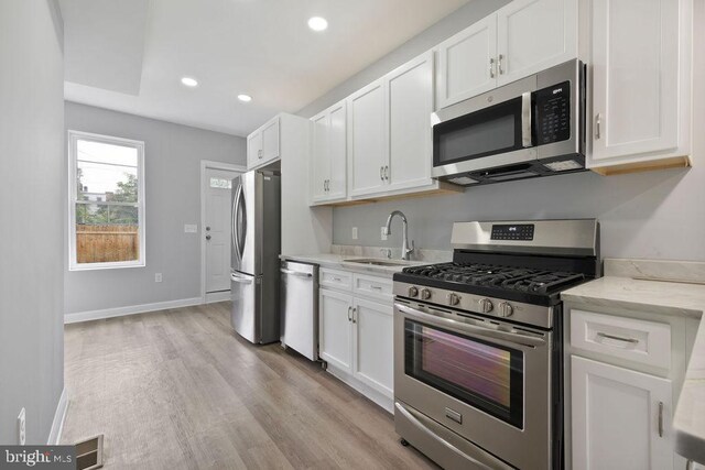 1815 N Warwick Ave, Baltimore, MD 21216 - kitchen featuring stainless steel appliances, white cabinetry, light wood-style flooring, and recessed lighting