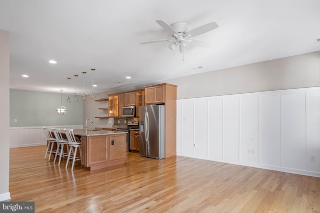2 Smithfield Ct Unit 8, Ocean View, DE 19970 - kitchen with appliances with stainless steel finishes, open shelves, light wood finished floors, a kitchen bar, and recessed lighting