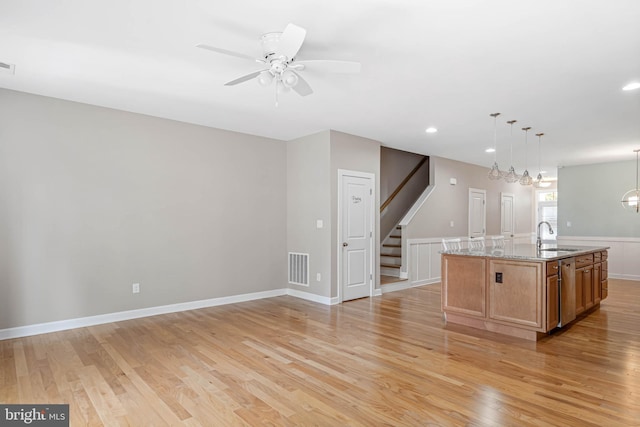 2 Smithfield Ct Unit 8, Ocean View, DE 19970 - kitchen with light wood-type flooring, ceiling fan, light stone countertops, an island with sink, and recessed lighting