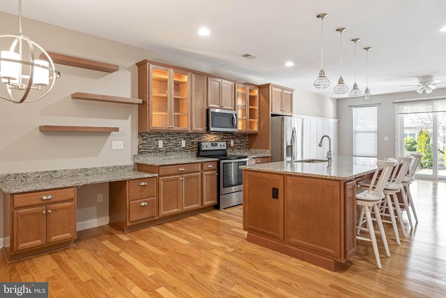 2 Smithfield Ct Unit 8, Ocean View, DE 19970 - kitchen with appliances with stainless steel finishes, light wood finished floors, decorative backsplash, brown cabinets, and recessed lighting