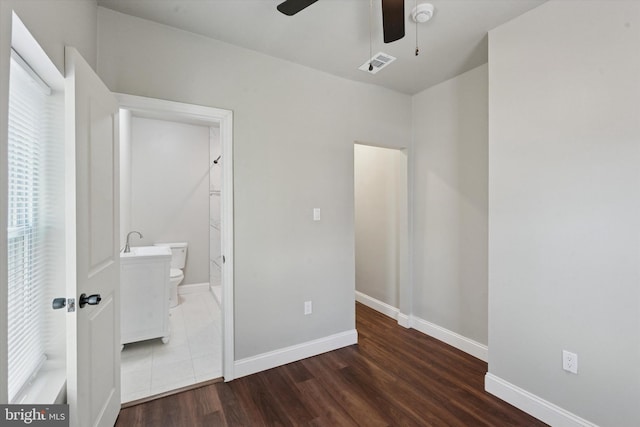 2419 Arlington St, Philadelphia, PA 19121 - unfurnished bedroom featuring wood finished floors, connected bathroom, and ceiling fan
