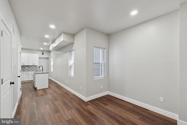 2419 Arlington St, Philadelphia, PA 19121 - kitchen with recessed lighting, dark wood-style floors, white cabinetry, decorative backsplash, and a center island with sink