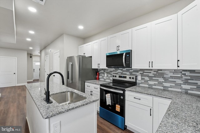 2419 Arlington St, Philadelphia, PA 19121 - kitchen featuring appliances with stainless steel finishes, decorative backsplash, white cabinetry, and recessed lighting