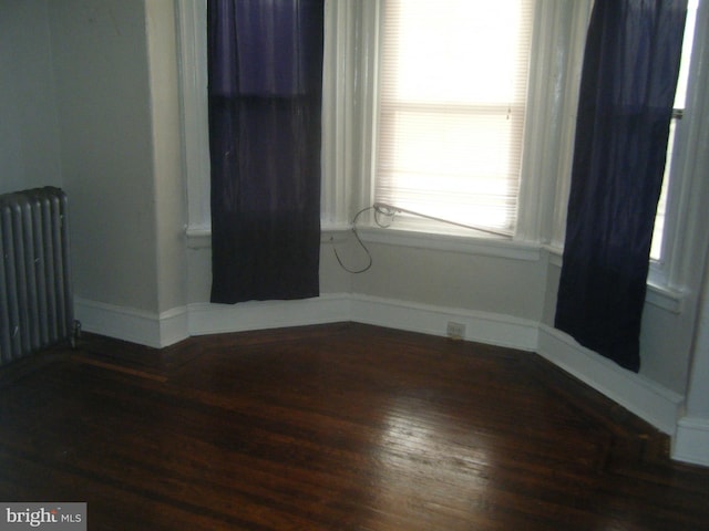 213 S 58th St, Philadelphia, PA 19139 - unfurnished room featuring radiator heating unit and wood finished floors