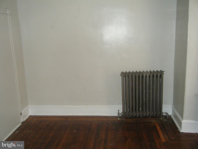 213 S 58th St, Philadelphia, PA 19139 - spare room featuring radiator and wood finished floors