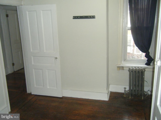 213 S 58th St, Philadelphia, PA 19139 - unfurnished bedroom featuring radiator and wood finished floors