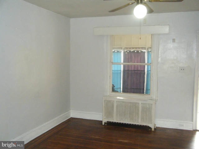 213 S 58th St, Philadelphia, PA 19139 - spare room with radiator heating unit, wood finished floors, and ceiling fan