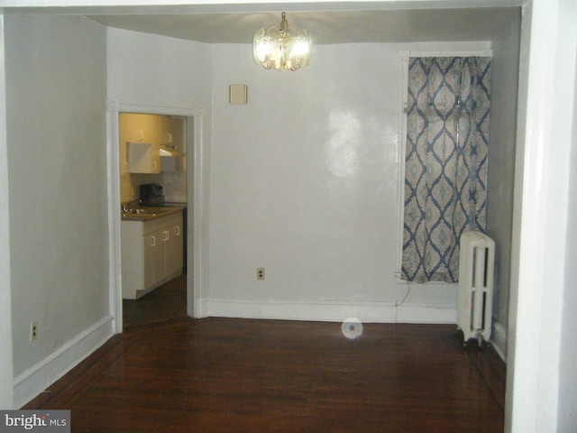 213 S 58th St, Philadelphia, PA 19139 - unfurnished dining area featuring radiator, dark wood-style flooring, and a chandelier