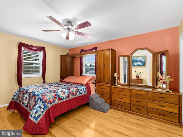 1811 Hilltop Ave, Baltimore, MD 21221 - bedroom featuring multiple windows, light wood finished floors, and a ceiling fan