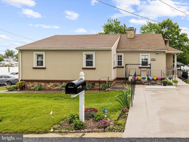 1811 Hilltop Ave, Baltimore, MD 21221 - back of property featuring a chimney, stucco siding, and a yard