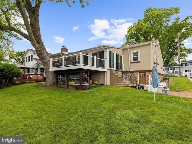 1811 Hilltop Ave, Baltimore, MD 21221 - back of house with a deck, a chimney, stairs, stucco siding, and a lawn