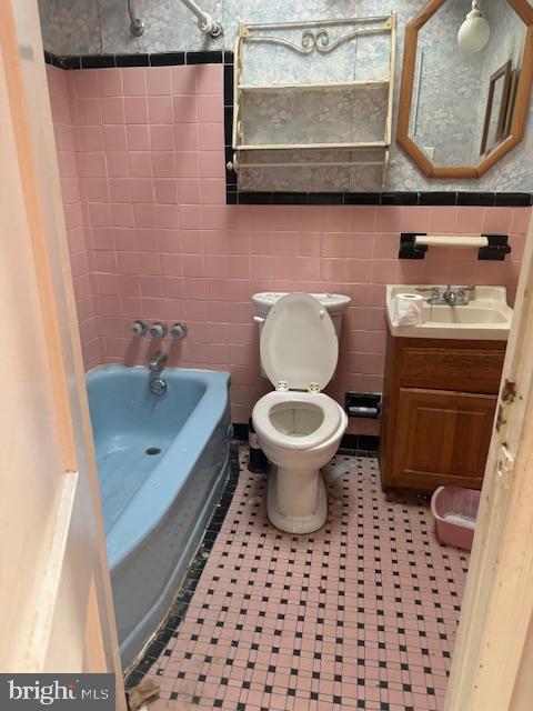 1814 S Newkirk St, Philadelphia, PA 19145 - bathroom featuring vanity, bathtub / shower combination, and tile walls