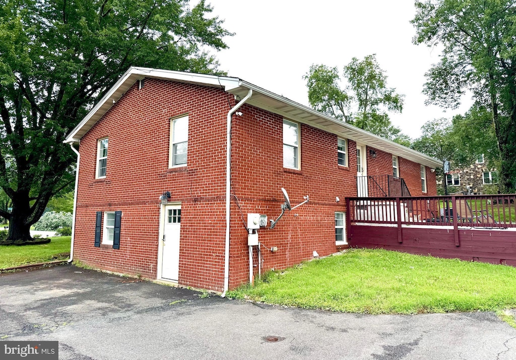 9912 S Grant Ave, Manassas, VA 20110 - view of property exterior featuring brick siding and a yard