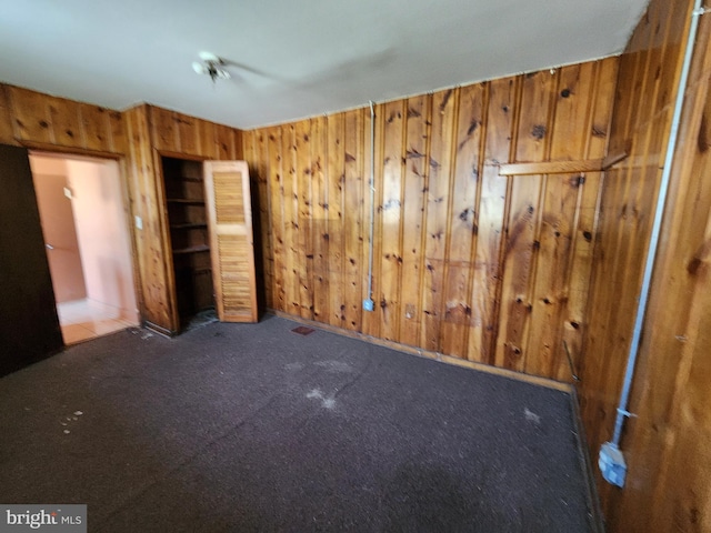 101 S Payson St, Baltimore, MD 21223 - unfurnished bedroom with wooden walls and carpet