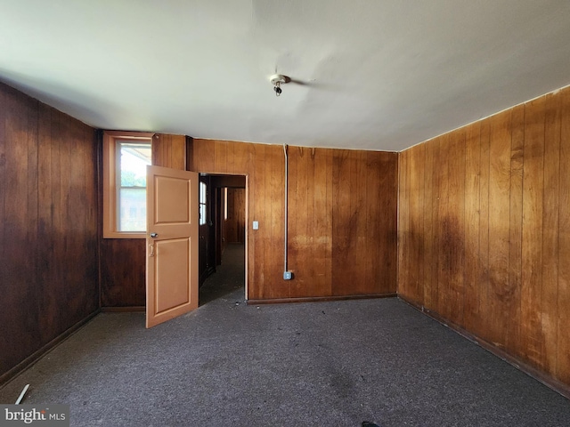 101 S Payson St, Baltimore, MD 21223 - carpeted spare room featuring wood walls
