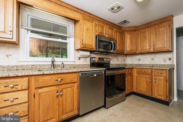 245 Greentree Dr, West Chester, PA 19382 - kitchen featuring stainless steel appliances, brown cabinets, and decorative backsplash