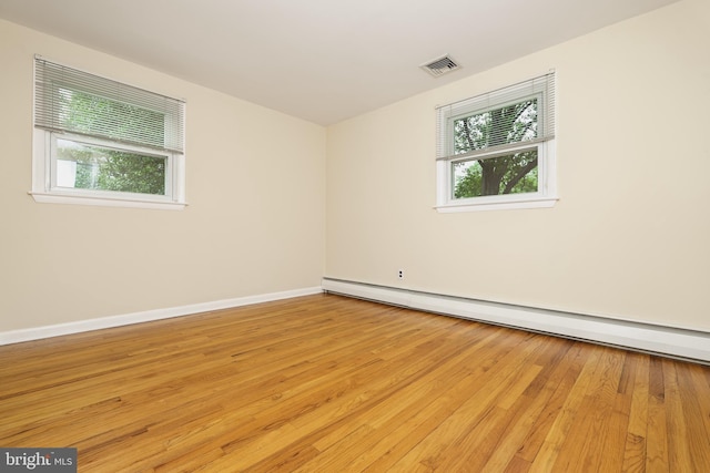 245 Greentree Dr, West Chester, PA 19382 - empty room with healthy amount of natural light, baseboard heating, and light wood-style floors