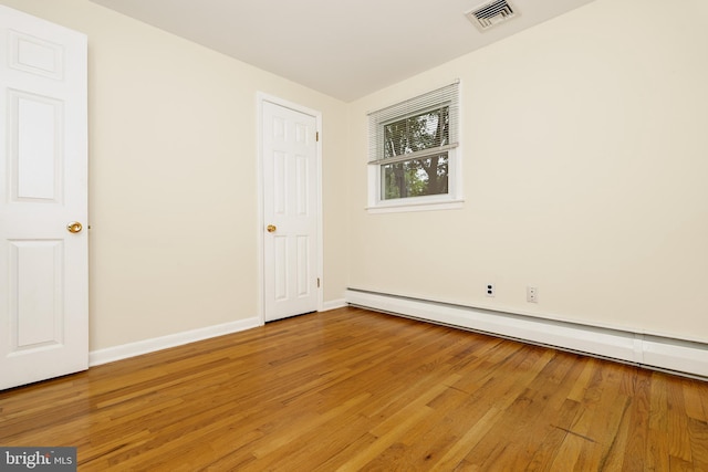 245 Greentree Dr, West Chester, PA 19382 - unfurnished bedroom featuring a baseboard heating unit and light wood finished floors