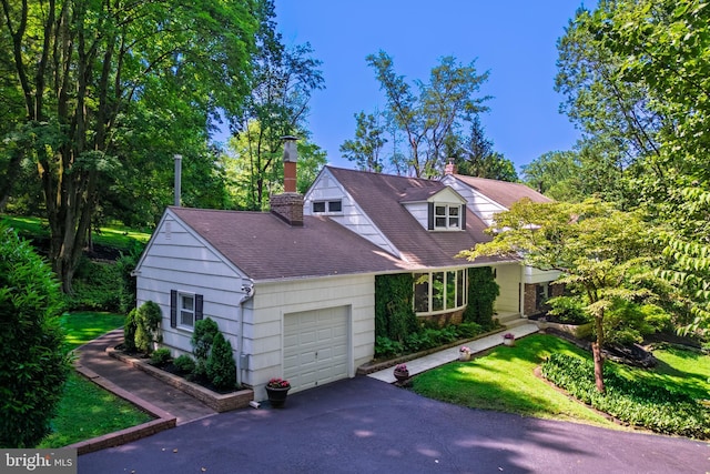 245 Greentree Dr, West Chester, PA 19382 - cape cod home featuring a garage, a chimney, driveway, and roof with shingles