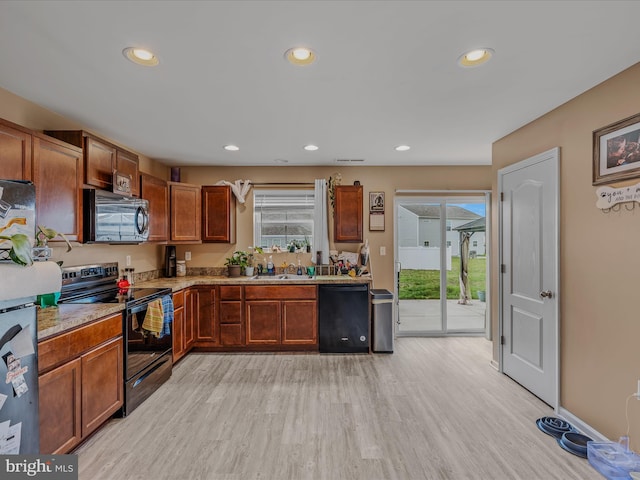 110 Tundra Ct, Bunker Hill, WV 25413 - kitchen with black appliances, recessed lighting, light wood-style floors, light stone countertops, and brown cabinets