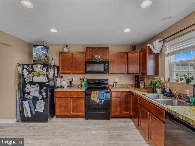 110 Tundra Ct, Bunker Hill, WV 25413 - kitchen with black appliances, light wood-style floors, light countertops, recessed lighting, and brown cabinetry