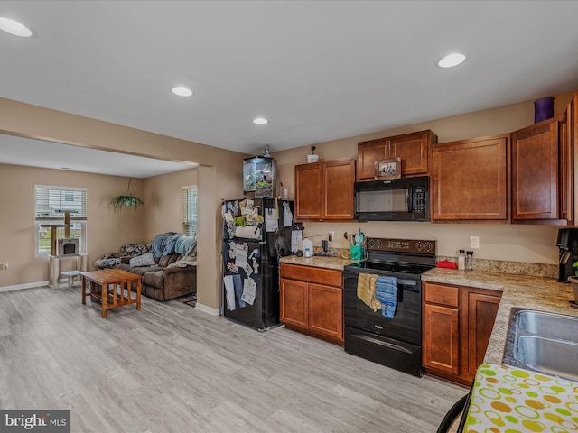 110 Tundra Ct, Bunker Hill, WV 25413 - kitchen with black appliances, light countertops, light wood-style floors, open floor plan, and recessed lighting