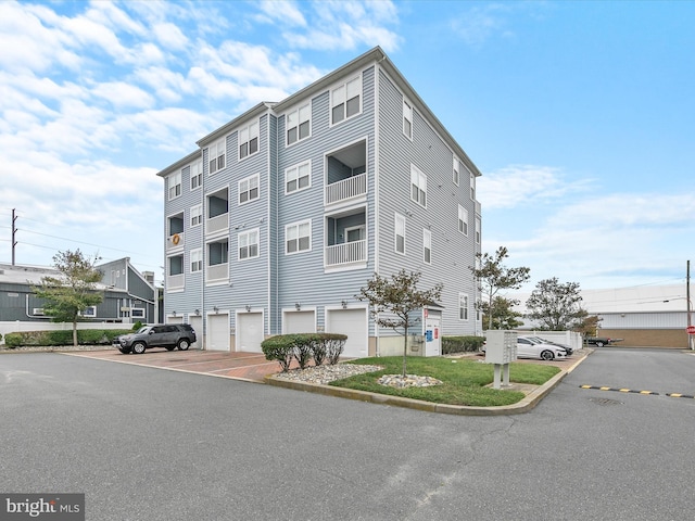 106 69th St Unit 13D, Ocean City, MD 21842 - view of building exterior with an attached garage
