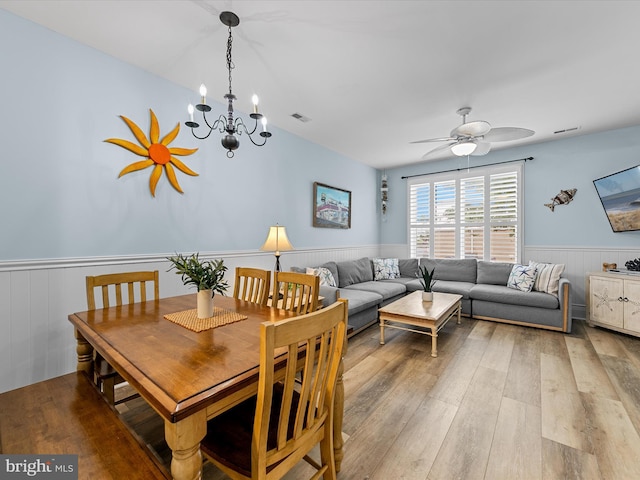 106 69th St Unit 13D, Ocean City, MD 21842 - dining area with wainscoting, wood finished floors, ceiling fan, and a chandelier