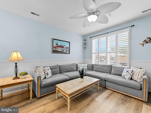 106 69th St Unit 13D, Ocean City, MD 21842 - living room featuring wainscoting, ceiling fan, and light wood finished floors