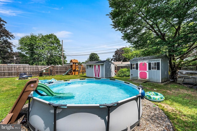 672 Austin Dr, Fairless Hills, PA 19030 - view of swimming pool featuring a shed, a playground, and a fenced backyard